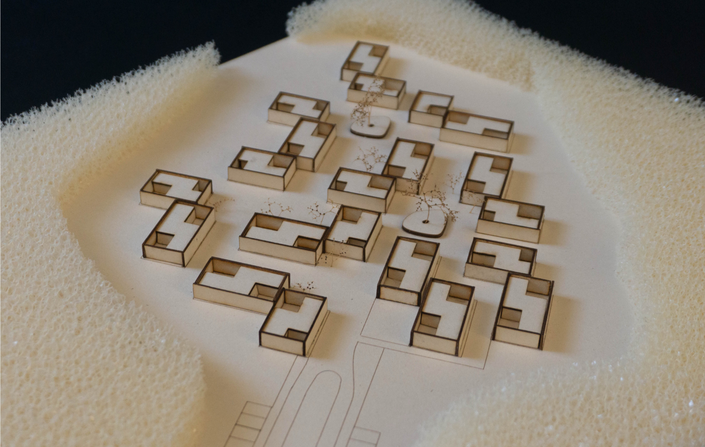Top view of the physical model showing multiple courtyard houses grouped as a residential cluster.