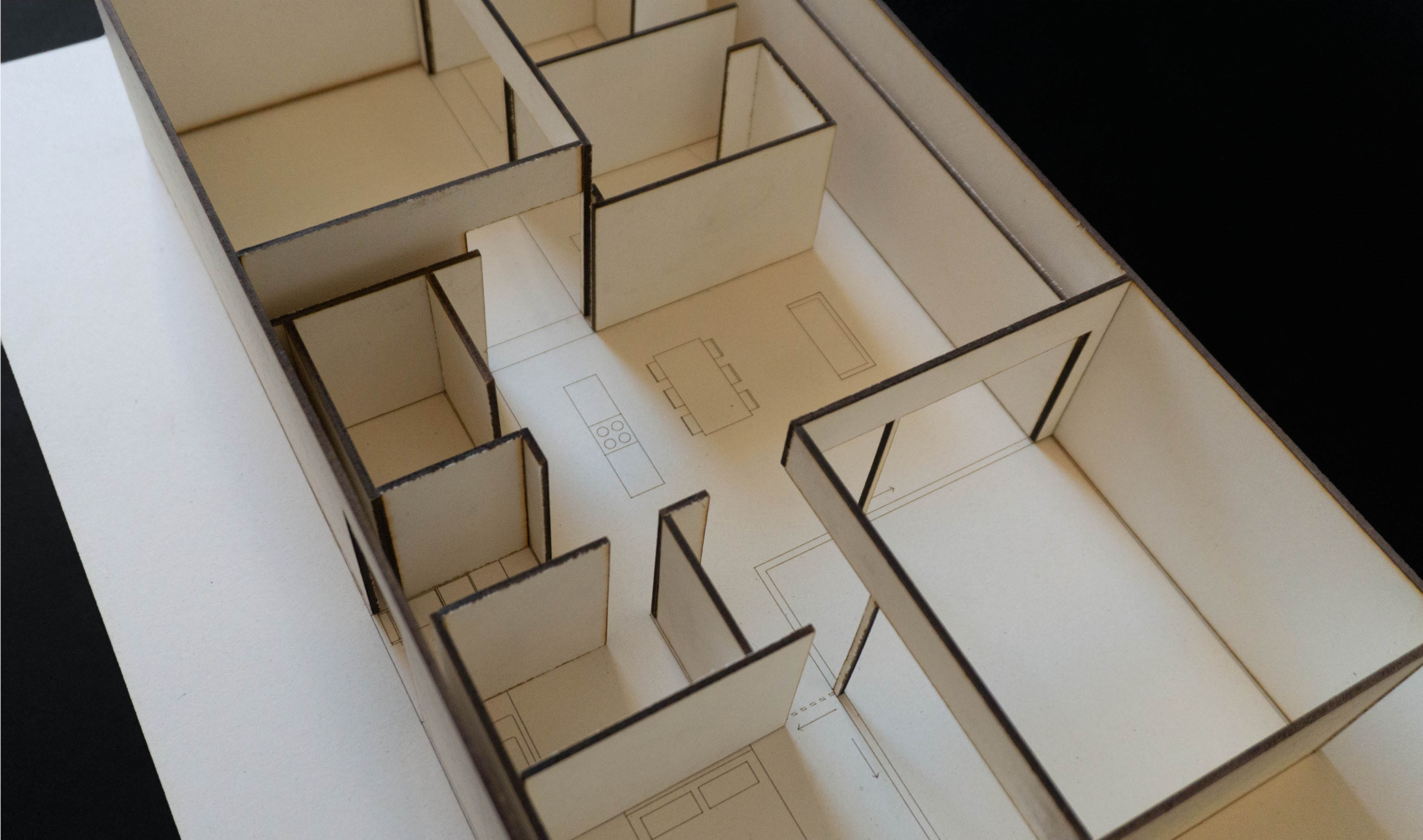 Close interior view of the physical courtyard house model showing rooms, partition walls, and built-in elements.