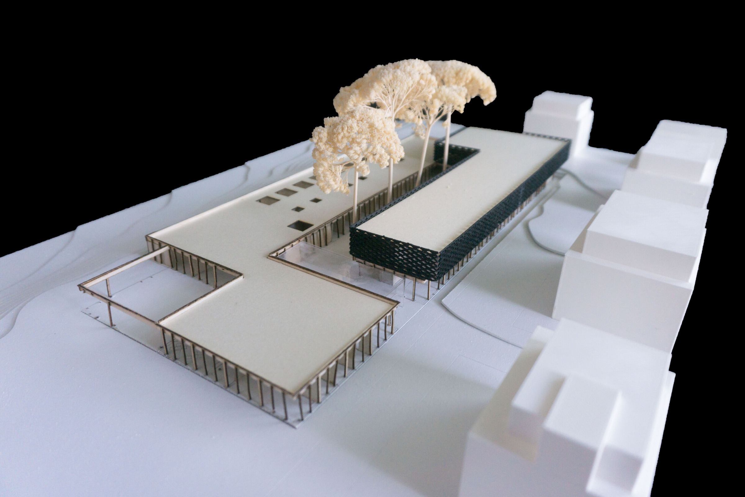 Physical model view of Hospiz Facettenreich showing the entrance sequence, courtyard volume and faceted upper body.