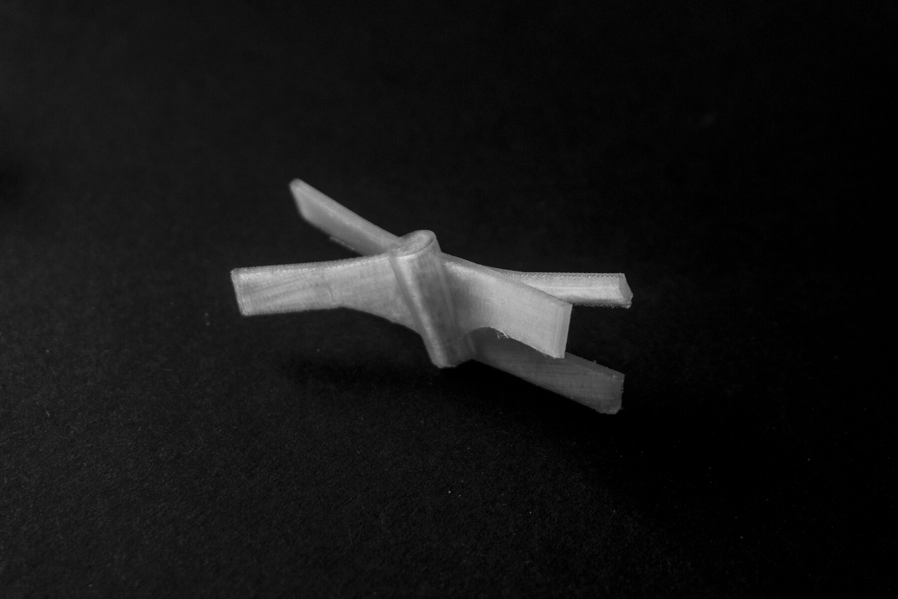 Side view of a translucent 3D printed node prototype on a dark background.